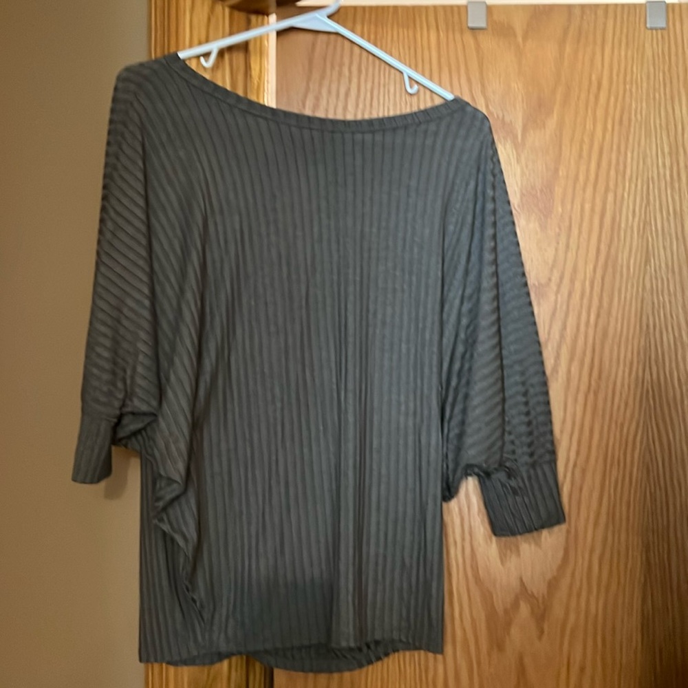 Beautiful green winged shirt with a green stripe pattern in the material.